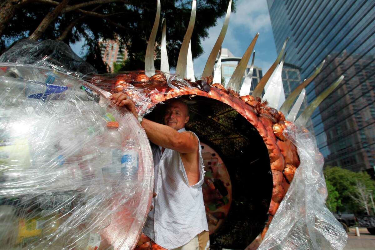 Eco Artist Mark Bradford assembles "NOMO" Trash Fish sculpture in the lake at Discovery Green on Thursday, April 5, 2012, in Houston. NOMO's belly is full of trash to illustrate the affects of polluted waters on marine life.