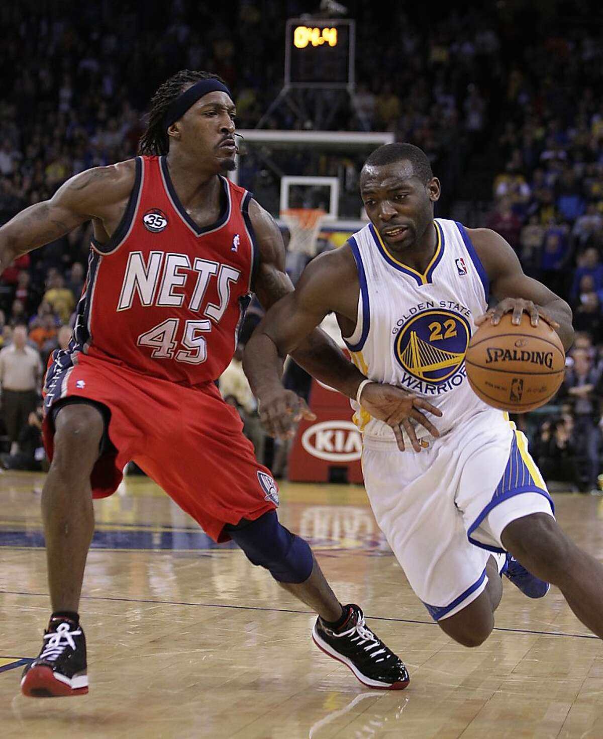 New Jersey Nets' Gerald Wallace, left, guards Golden State Warriors' Charles Jenkins (22) during the second half of an NBA basketball game Friday, March 30, 2012, in Oakland, Calif. (AP Photo/Ben Margot)