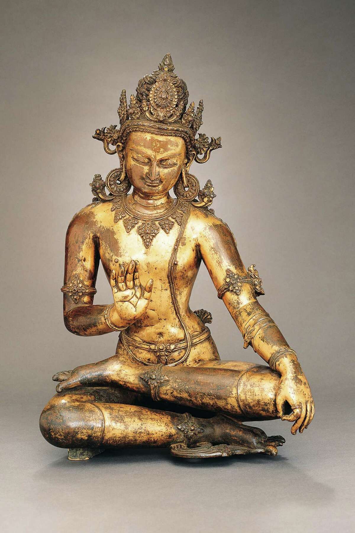 Seated Bothisattva, a 13th century Nepalese sculpture in gilt copper with semiprecious stone inlays, is among the treasures on display at the Asia Society Texas Center exhibit "Treasures of Asian Art: A Rockefeller Legacy".