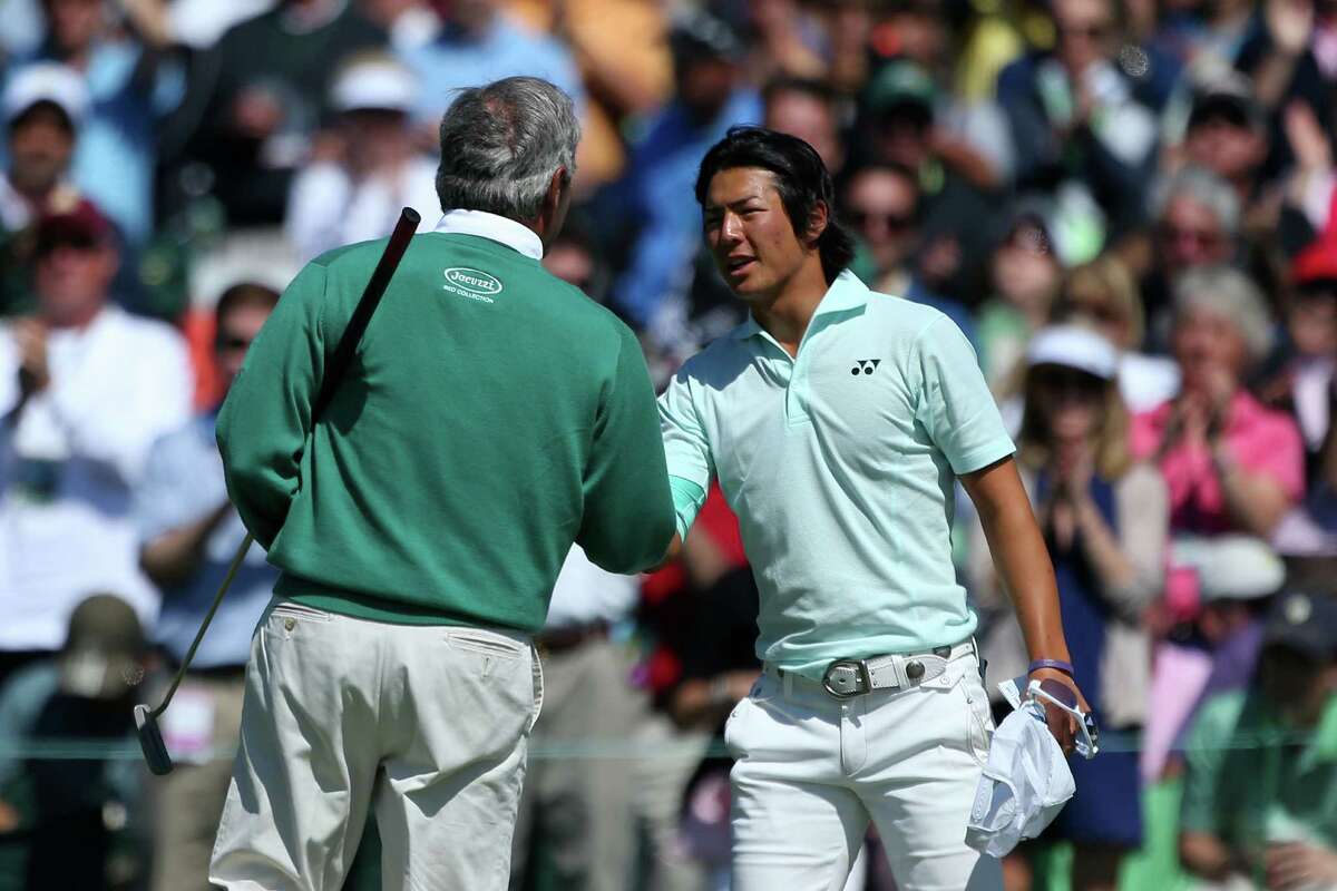 AUGUSTA, GA - APRIL 06: Fred Couples (R) of the United States shakes hands with Ryo Ishikawa of Japan on the 18th green after finishing the second round of the 2012 Masters Tournament at Augusta National Golf Club on April 6, 2012 in Augusta, Georgia.