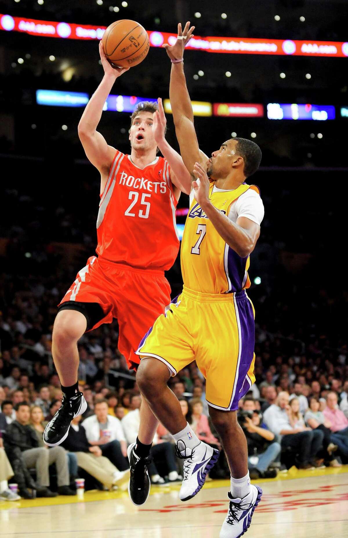 Houston Rockets forward Chandler Parsons (25) attempts to get by Los Angeles Lakers guard Ramon Sessions (7) on a fast break in the first half of an NBA basketball game, Friday, April 6, 2012, in Los Angeles. (AP Photo/Gus Ruelas)