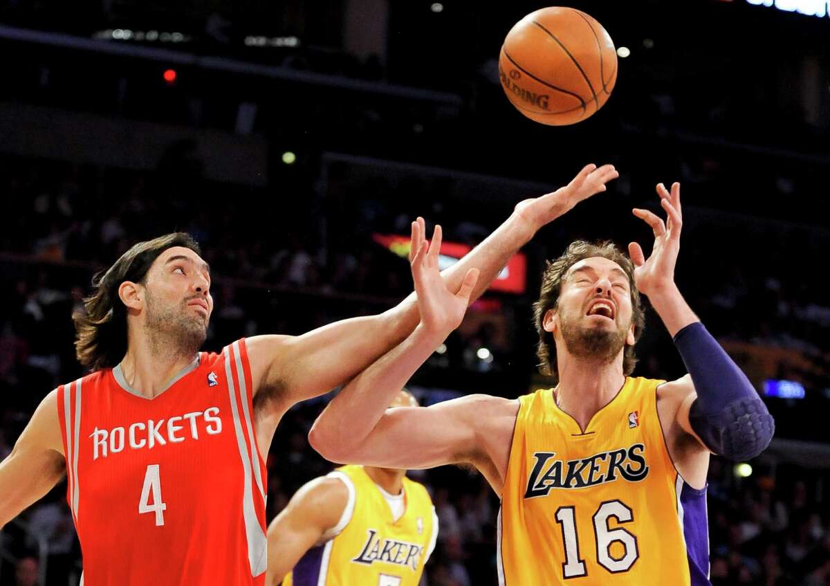 Houston Rockets forward Luis Scola (4), of Argentina, and Los Angeles Lakers forward Pau Gasol (16), of Spain, fight for a loose ball in the first half of an NBA basketball game, Friday, April 6, 2012, in Los Angeles. (AP Photo/Gus Ruelas)