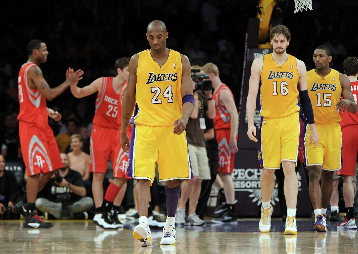LOS ANGELES, CA - APRIL 06: Kobe Bryant #24 of the Los Angeles Lakers, Pau Gasol #16 and Metta World Peace #15 leave the court after losing to the Houston Rockets 112-107 at Staples Center on April 6, 2012 in Los Angeles, California. NOTE TO USER: User expressly acknowledges and agrees that, by downloading and or using this photograph, User is consenting to the terms and conditions of the Getty Images License Agreement. (Photo by Harry How/Getty Images)