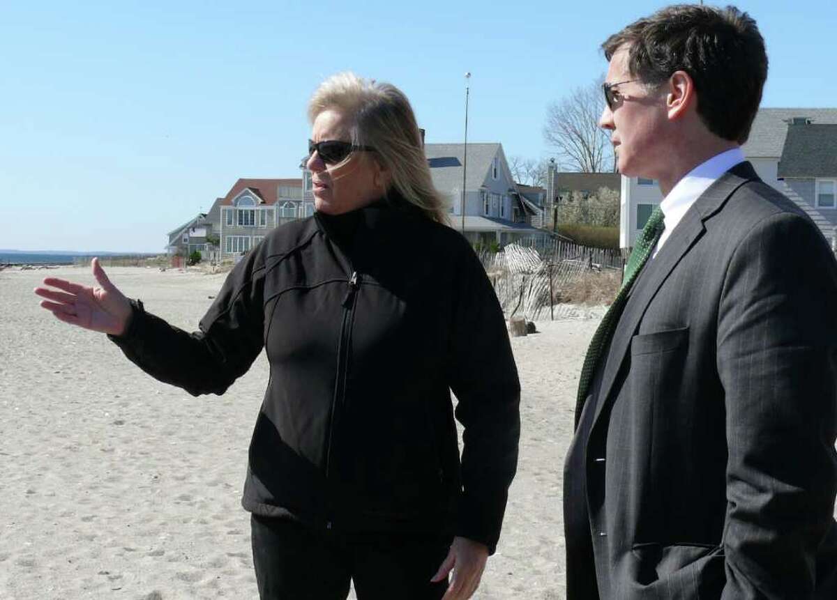 Kathy Strachan, chairman of the Fairfield Beach Residents Association's Erosion Committee, discusses the shifting beach sands along Fairfield Beach Road with state Department of Energy and Environmental Protection Commissioner Daniel Esty Tuesday.