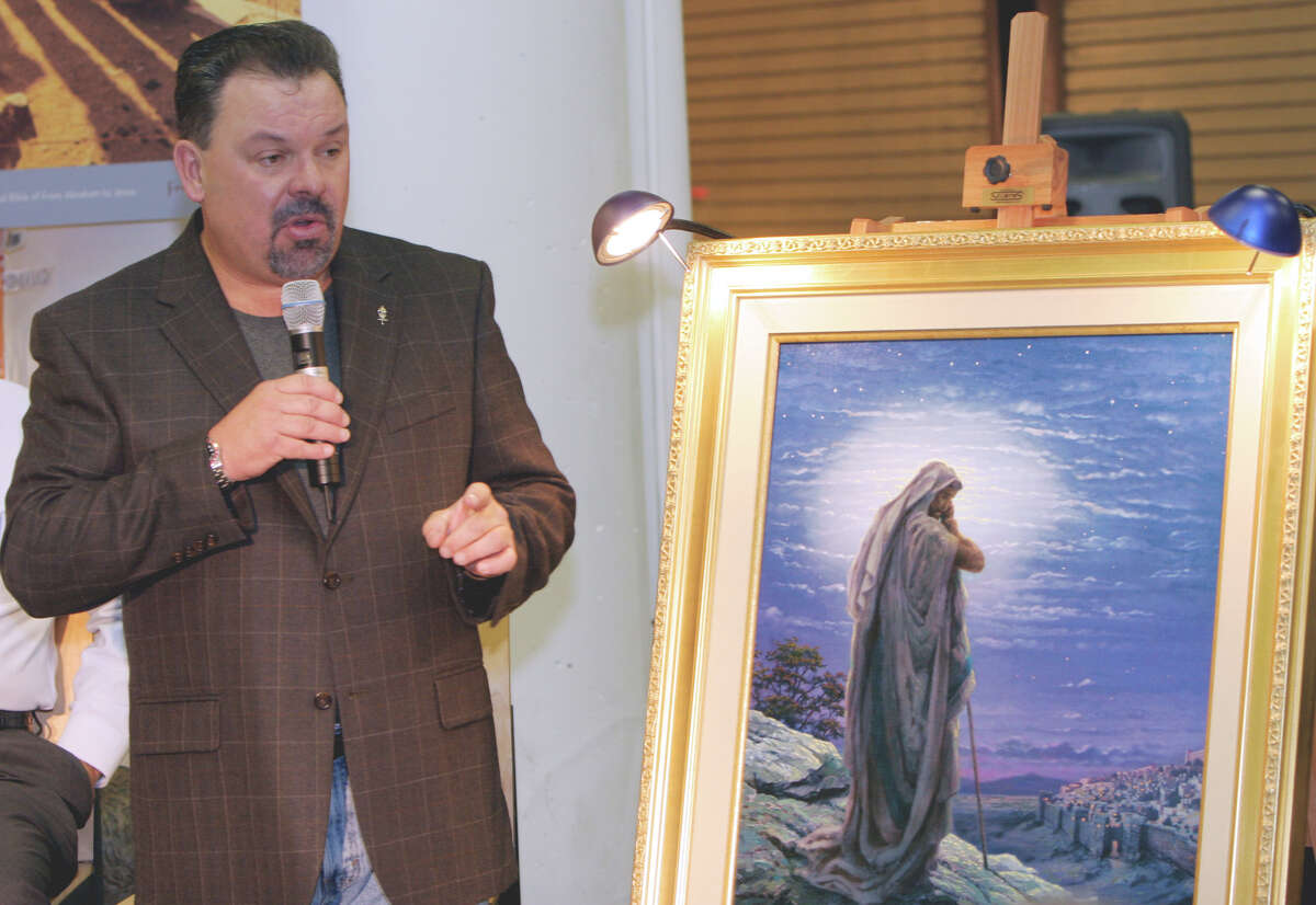 Thomas Kinkade unveils his painting, "Prayer For Peace," at the opening of the exhibit "From Abraham to Jesus," in Atlanta in September 2006. Kinkade died Friday at 54.