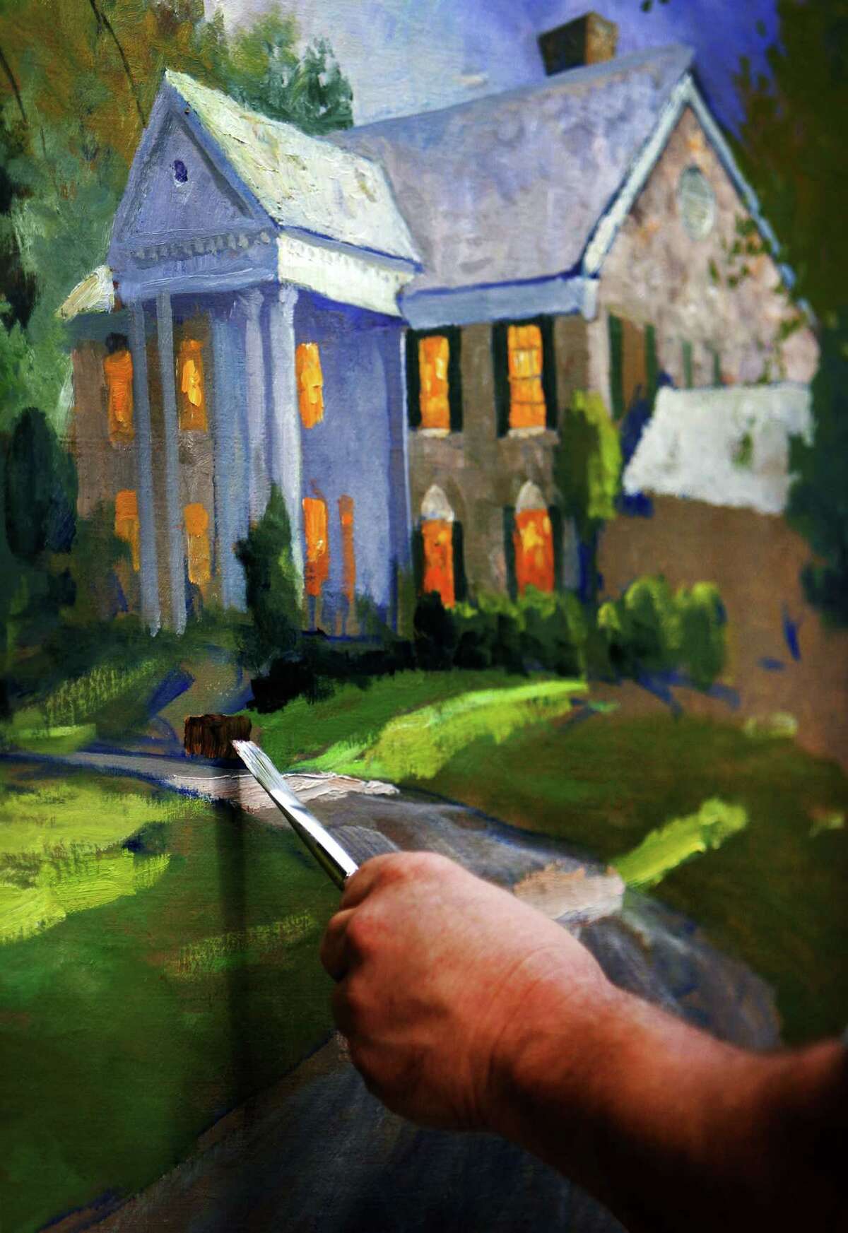 FILE - In this Sept. 22, 2006 file photo, artist Thomas Kinkade works on a study of Graceland in Memphis, Tenn. Kinkade, whose brushwork paintings of idyllic landscapes, cottages and churches have been big sellers for dealers across the United States, died Friday, April 6, 2012, a family spokesman said. (AP Photo/The Commercial Appeal, Jim Weber, File) MEMPHIS OUT, MAGS OUT, TV OUT, NO SALES