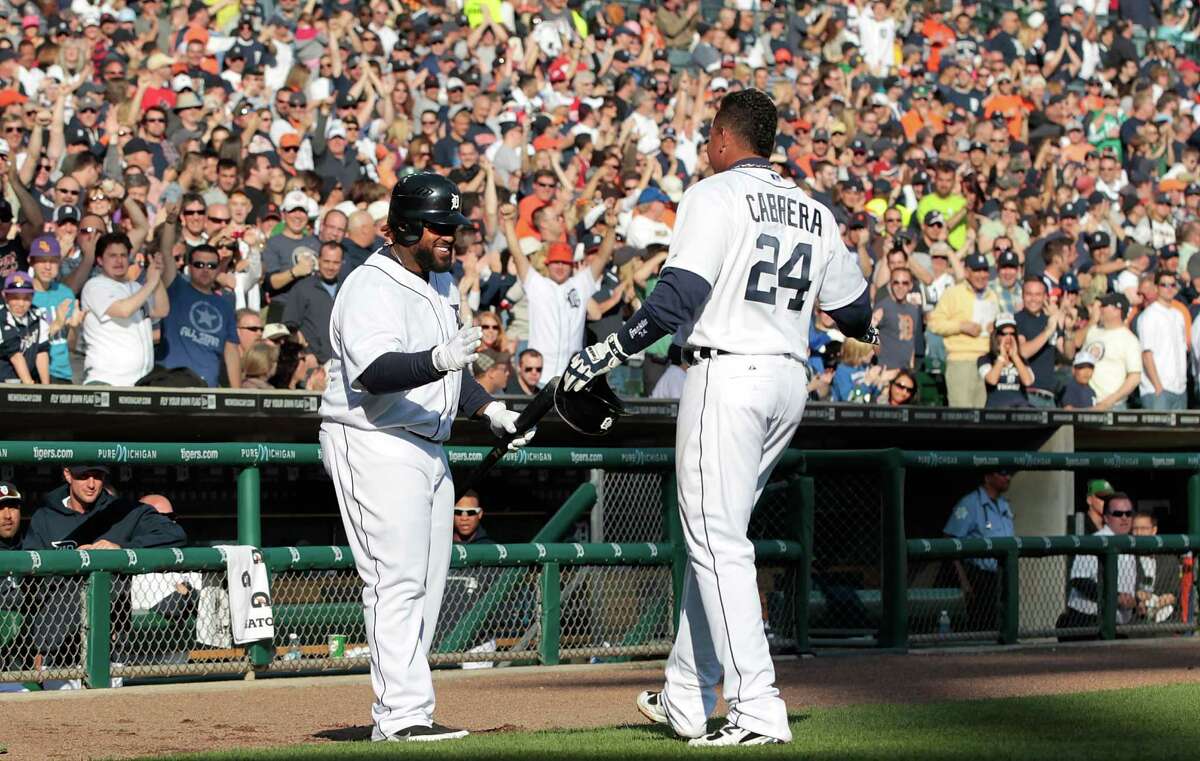Detroit's Prince Fielder, left, greets teammate Miguel Cabrera after Cabrera hit one of his two home runs Saturday in the fifth inning of the Tigers' 10-0 victory over Boston. Not to be outdone, Fielder also homered twice in the game.