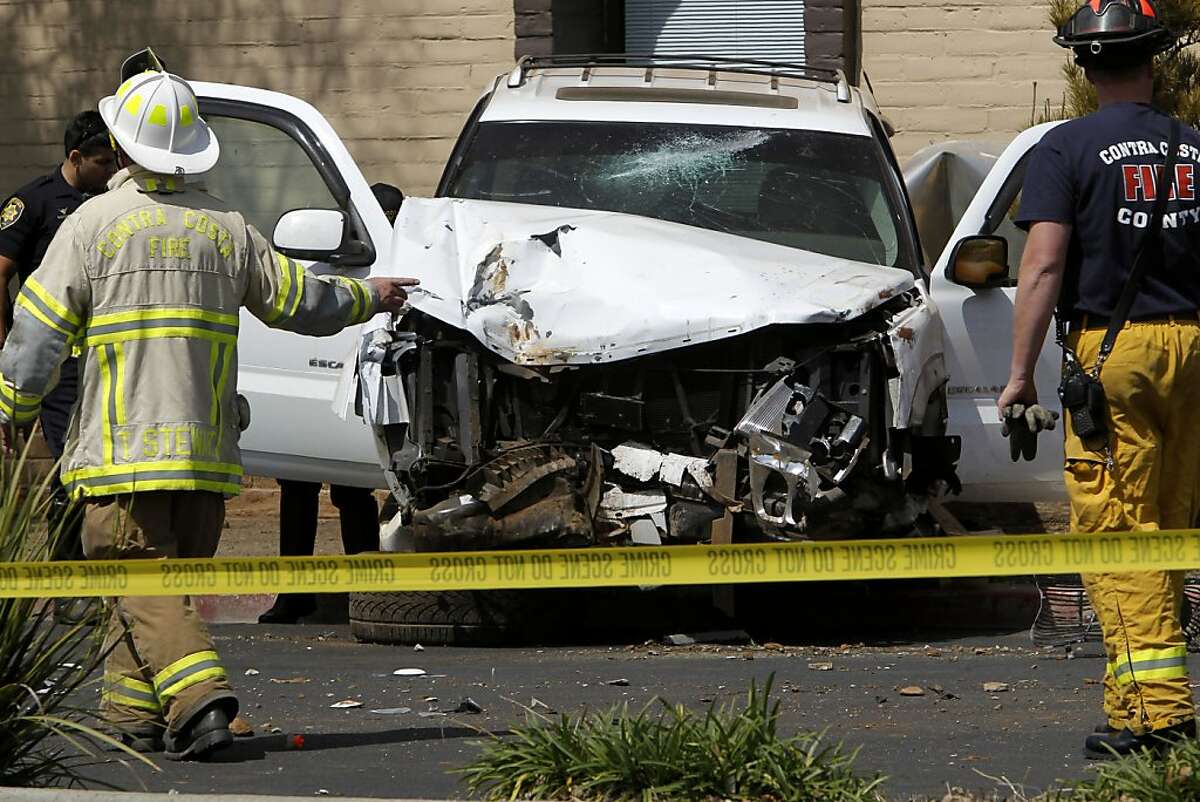 The wrecked SUV sits on the sidewalk as the investigation of the scene continues after a 17-year-old male driver is being charged with manslaughter when the vehicle he was driving hit 3 bicyclists on Treat Blvd. at Oak Grove in Concord, Ca. killing a father, Soliaman Nuri, and his 9-year-old daughter Hodees Nuri, and leaving a second daughter, a 12-year-old with minor injuries, on Saturday April 7, 2012.
