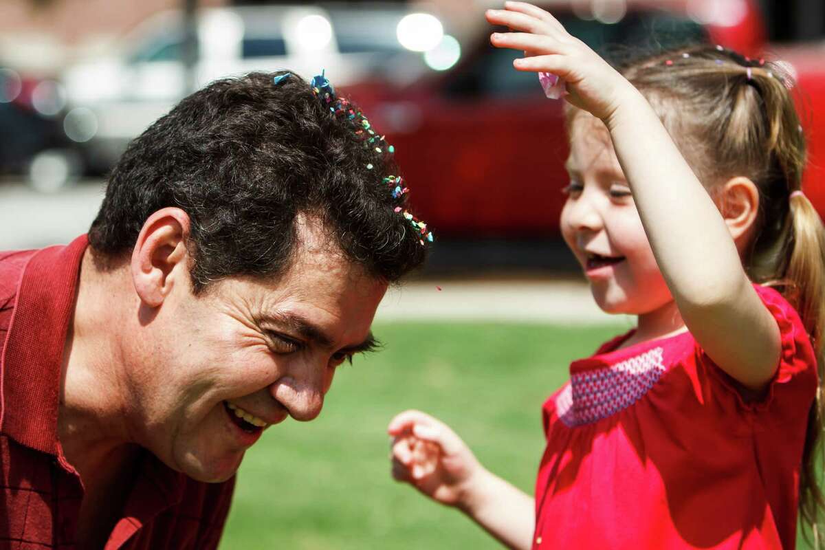 Victor Delarosa (left) has a confetti egg crushed on his head by his daughter, Mariana, 6, after the Easter egg hunt at Easter at the Park presented by St. Luke's United Methodist Church, at Discovery Green, Sunday, April 8, 2012, in Houston. The worship celebration featured a fusion of contemporary Christian and hip hop music with Faith Ayers and the Encounter Band, DJ Psycho, and the Youth Advocates Break Dancers. The celebration continued with open circle break dancing and fun children's crafts and activities including, of course, an Easter egg hunt.