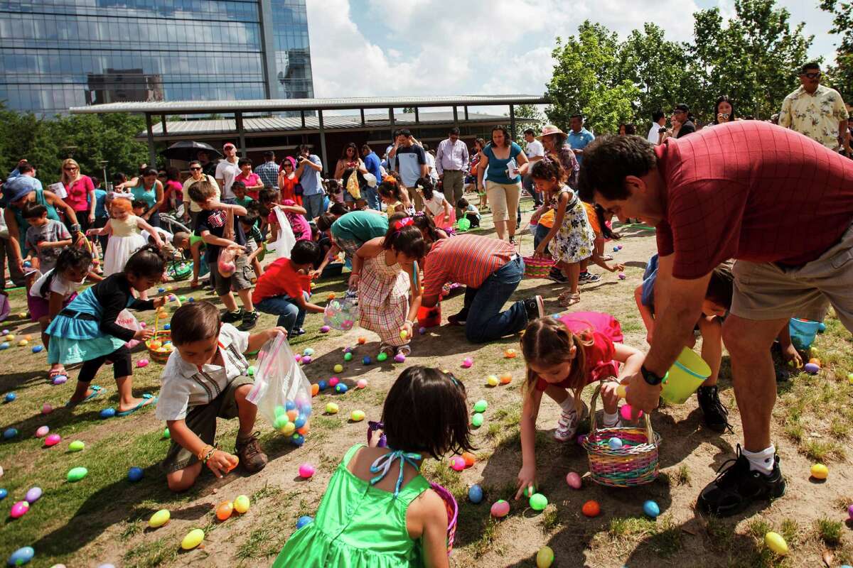 Victor Delarosa (right) helps his daughter, Mariana, 6, collect eggs during the Easter egg hunt at Easter at the Park presented by St. Luke's United Methodist Church, at Discovery Green, Sunday, April 8, 2012, in Houston. The worship celebration featured a fusion of contemporary Christian and hip hop music with Faith Ayers and the Encounter Band, DJ Psycho, and the Youth Advocates Break Dancers. The celebration continued with open circle break dancing and fun children's crafts and activities including, of course, an Easter egg hunt.