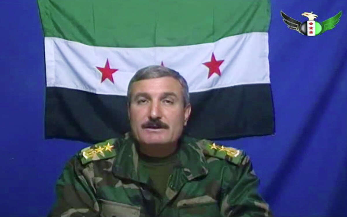 FILE - In this Nov. 21, 2011 file image made from video, Syrian Commander Riad al-Asaad, who heads a group of Syrian army defectors appears on a video posted on the group's Facebook page, as he retracts earlier claims that his followers launched an attack on Baath Part Headquarters inside the Syrian capital, Damascus. A U.N.-brokered peace deal for Syria appeared to collapse Sunday as the government made a new demand that its opponents provide "written guarantees" to lay down their weapons before regime forces withdraw from cities, a call swiftly rejected by the country's main rebel group. The commander of the rebel Free Syrian Army, Riad al-Asaad, said his group was prepared to abide by the Annan agreement, but rejected the government's new unilateral demand. (AP Photo/Facebook, File) THE ASSOCIATED PRESS HAS NO WAY OF INDEPENDENTLY VERIFYING THE CONTENT, LOCATION OR DATE OF THIS VIDEO IMAGE.