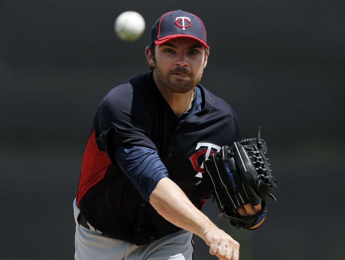 Minnesota Twins starting pitcher Liam Hendriks warms up before a spring training baseball game in Lakeland, Fla., Wednesday, March 21, 2012. (AP Photo/Paul Sancya)