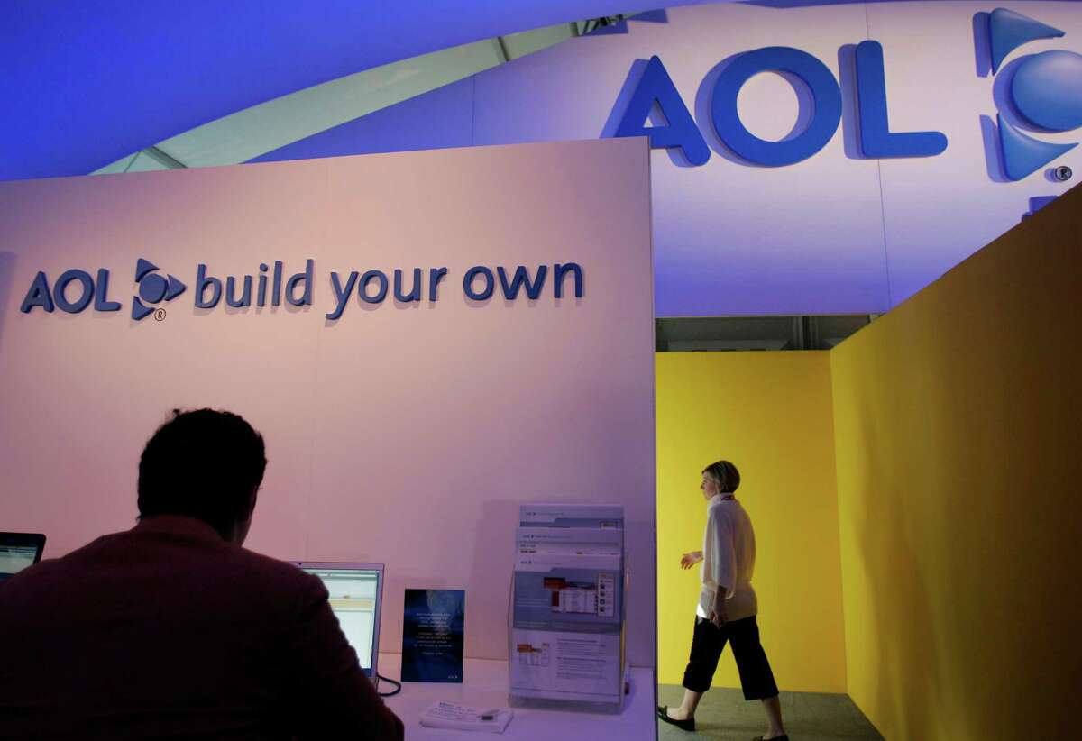 FILE - In this Jan. 7, 2008 file photo, a show attendee leaves the AOL booth at the Consumer Electronics Show (CES) in Las Vegas. AOL Inc. shares surged Monday, April 9, 2012, to their highest level in more than a year after it said it has agreed to sell 800 of its patents and license others to Microsoft Corp. for about $1.06 billion in cash. (AP Photo/Paul Sakuma, File)