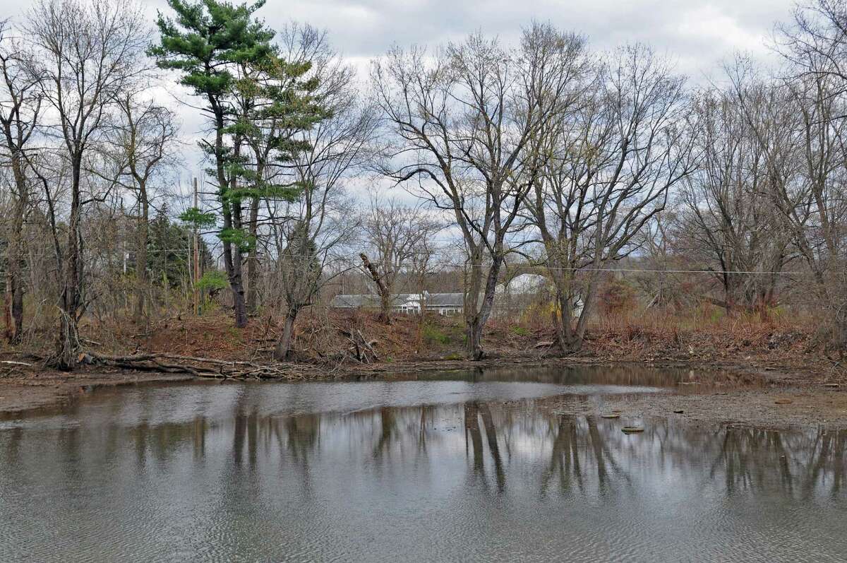 The Town of Halfmoon approved a plan to build hundreds of condominiums, a clubhouse, town park and boat slips. View of a structure beyond the Krause's sign, as seen from Canal Road, on Monday April 9, 2012 in Halfmoon, NY. (Philip Kamrass / Times Union )