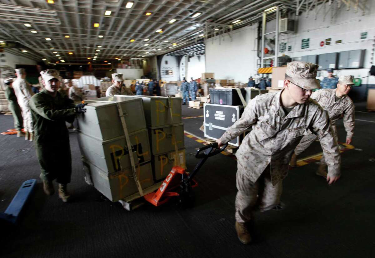 FILE - In this March 8, 2012 file photo, sailors move supplies and equipment as they prepare for the final deployment of the nuclear aircraft carrier USS Enterprise at the Norfolk Naval Station in Norfolk, Va. The U.S. Navy said Monday, April 9, 2012 that it has deployed a second aircraft carrier to the Persian Gulf region amid rising tensions with Iran over its nuclear program. The deployment of the nuclear-powered USS Enterprise along the Abraham Lincoln carrier strike group marks only the fourth time in the past decade that the Navy has had two aircraft carriers operating at the same time in the Persian Gulf and the Arabian Sea, said Cmdr. Amy Derrick-Frost of the Bahrain-based 5th Fleet. (AP Photo/Steve Helber, File)