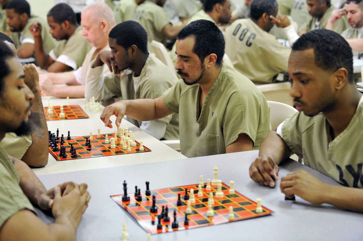Inmates play chess as part of a new chess program being implemented at the Cook County Jail in Chicago, Monday, Monday, April 2, 2012. Cook County Sheriff Tom Dart introduced the new chess program in hopes the inmates can learn a thing or two from a game that rewards patience, responsibility and problem solving. (AP Photo/Chicago Sun-TImes, Brian Jackson) CHICAGO LOCALS OUT, MAGS OUT