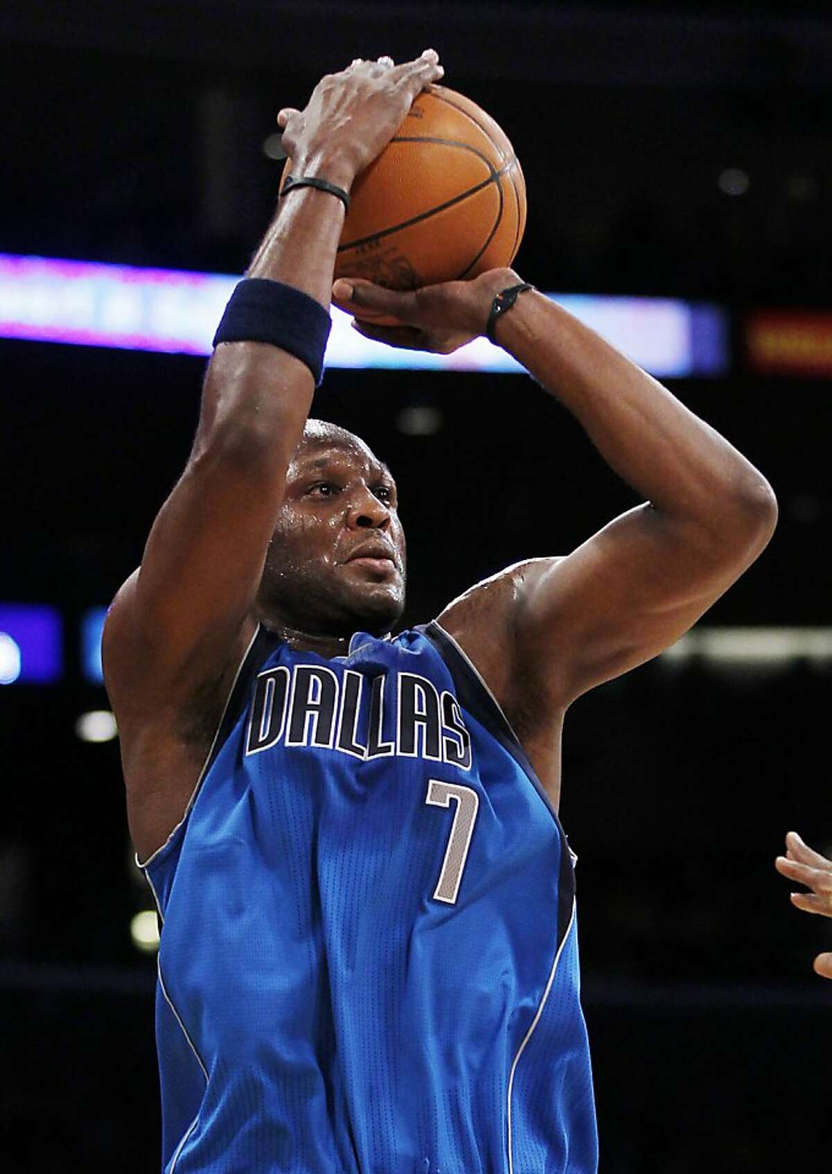 FILE - This Jan. 16, 2012 file photo shows Dallas Mavericks' Lamar Odom makin g a three-point shot against the Los Angeles Lakers during the first quarter of an NBA basketball game in Los Angeles. The NBA's reigning Sixth Man of the Year, who was shipped to Dallas after the Los Angeles Lakers tried to send him to New Orleans in the Chris Paul deal that was nixed by the league, will not play the rest of the season for the Mavericks, according to a person familiar with the decision who spoke Monday, April 9, 2012, on condition of anonymity because an official announcement had not been made. (AP Photo/Danny Moloshok, File)