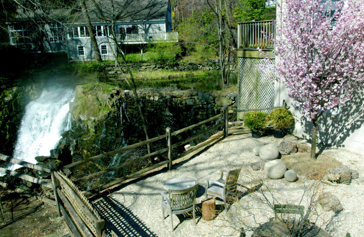 SPECTRUM/A cherry tree blooms in early spring on the patio at Pergola Home in Nature in New Preston, overlooking New Preston Falls. April 2012