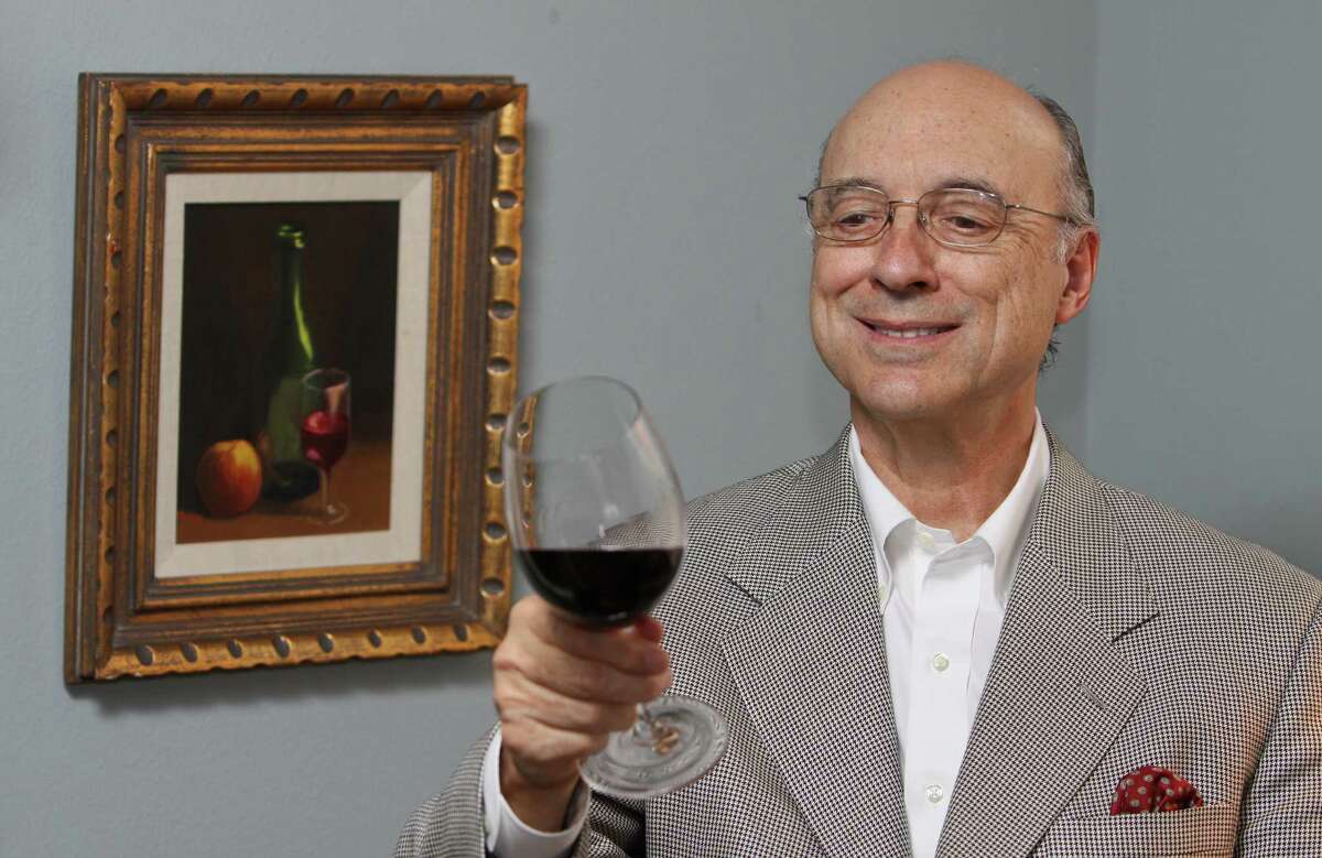 (For the Chronicle/Gary Fountain, April 4, 2012) Denman Moody enoying a glass of wine. He is sitting by a oil painting by his wife, painted prior to their meeting each other.