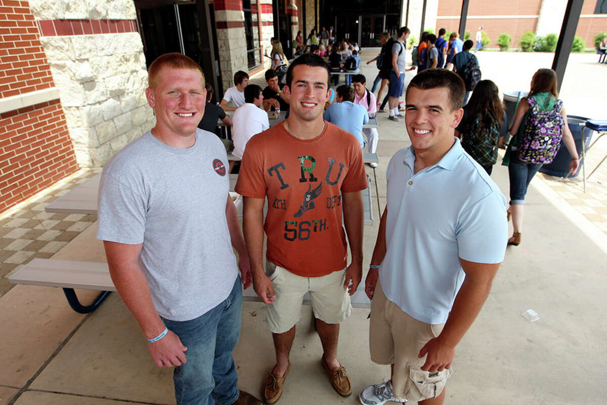 Johnson High School Senior football players, Austin Carson, 18, Cohner Mokry, 17, Ryder Burke, 18, participate in a program to reduce bullying at the school.