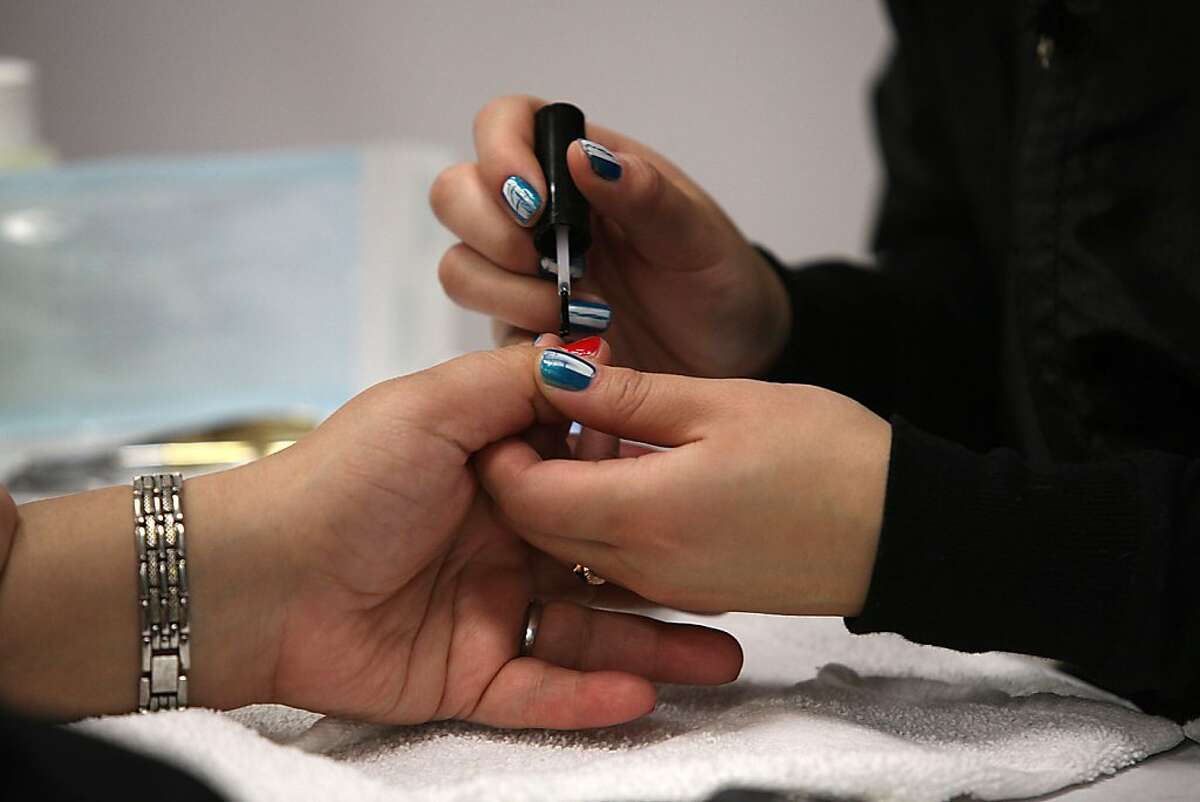 Student Christine Nguyen from Oakland doing the nails of Nini Trinh at Laney College School of Cosmetology in Oakland, Calif., on Tuesday, April 10, 2012.