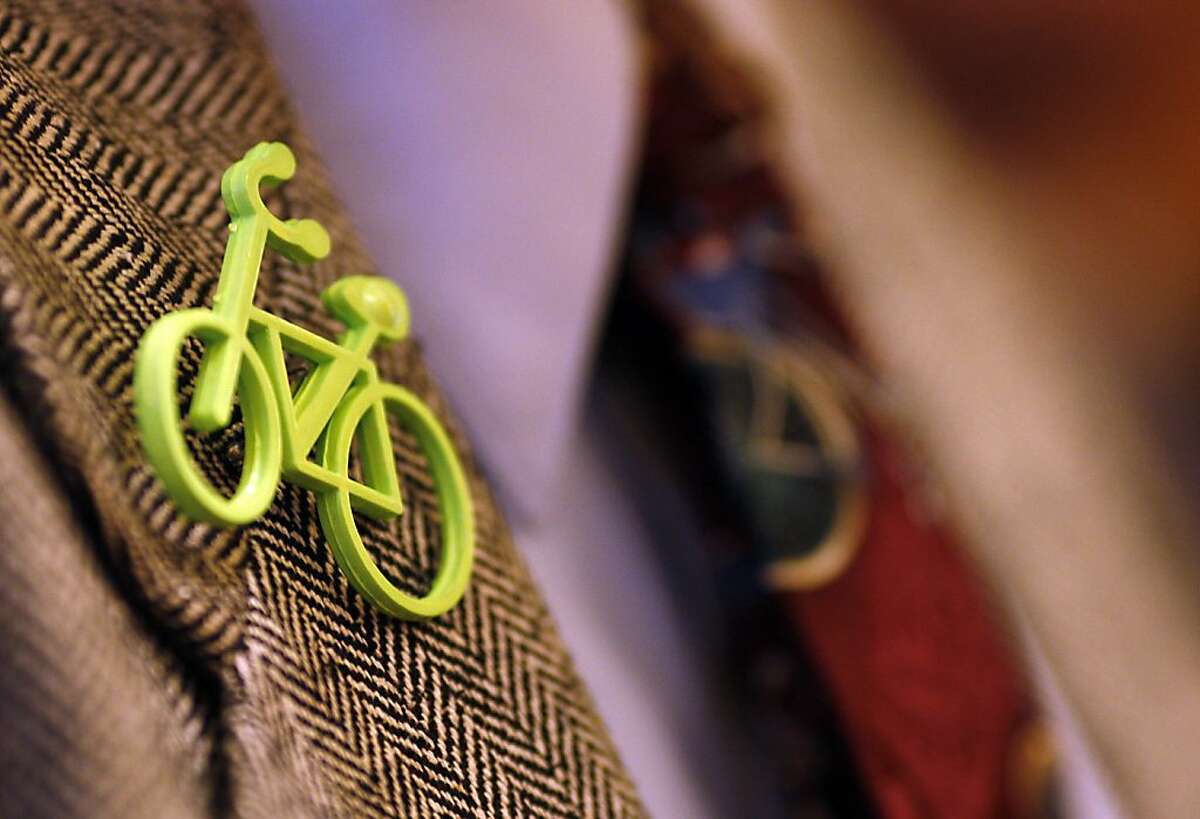 Bert Hill, chair of the Bicycle Advisory Committee, wears a bicycle pin and tie during a meeting where Board of Supervisors President David Chiu and other city leaders announced new efforts to improve street safety for pedestrians, bicyclists and drivers at City Hall in San Francisco, Calif. on April 10, 2012.