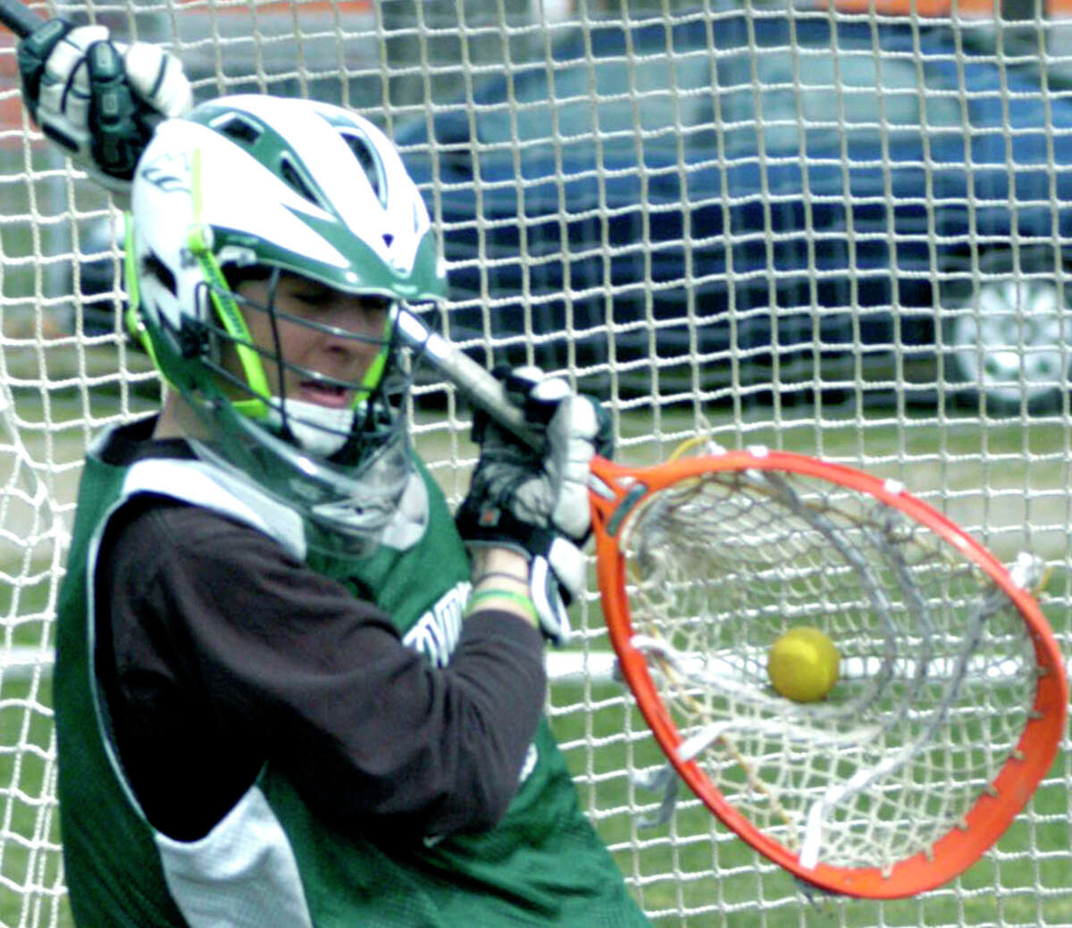 SPECTRUM/The quick hands of Green Wave goaltender Matt Lalli secure a save during pre-season practice for New Milford High School boys' lacrosse. April 2012