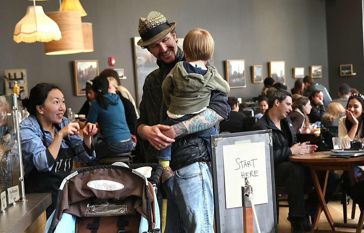 Cortt Dunlap,(middle) managing partner of Awaken Cafe, which opened two months ago in Oakland, Calif., as he is about to leave with his son Keaton Dunlap, 21 mos. old, on Tuesday, April 10, 2012.