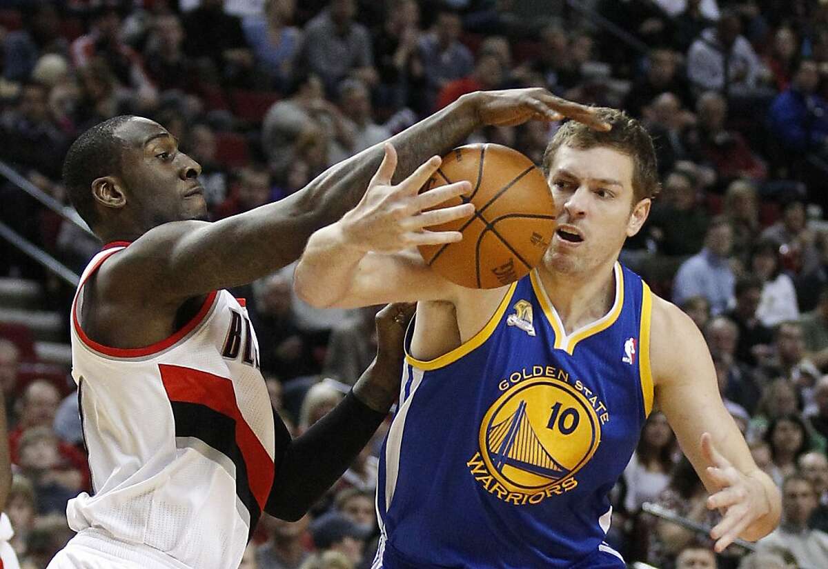 Golden State Warriors' David Lee (10) loses control of the ball as Portland Trail Blazers' J.J. Hickson reaches for it during the first quarter of an NBA basketball game Wednesday, April 11, 2012, in Portland, Ore.