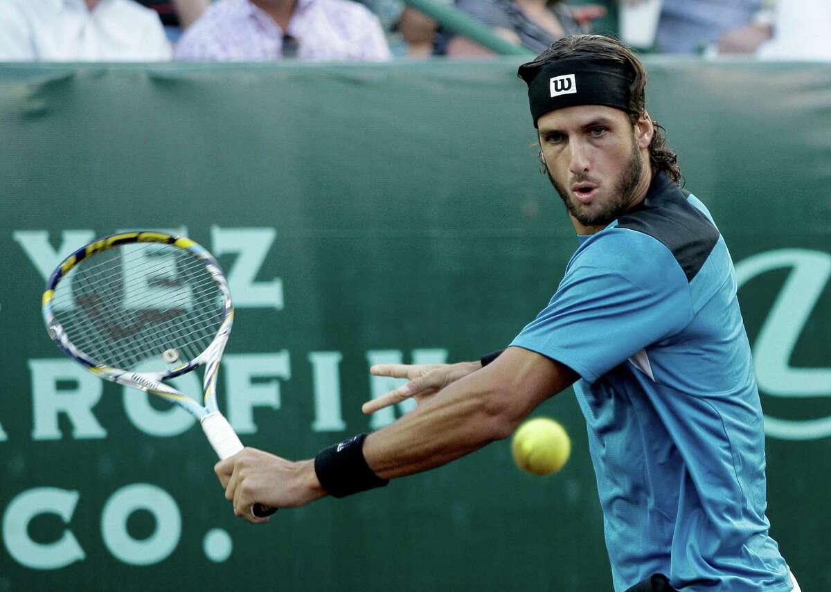 April 11 - Feliciano Lopez returns a serve to Paolo Lorenzi in the first set at the Clay Courts tennis tournament at River Oaks Country Club in Houston, Texas. For the Chronicle: Thomas B. Shea