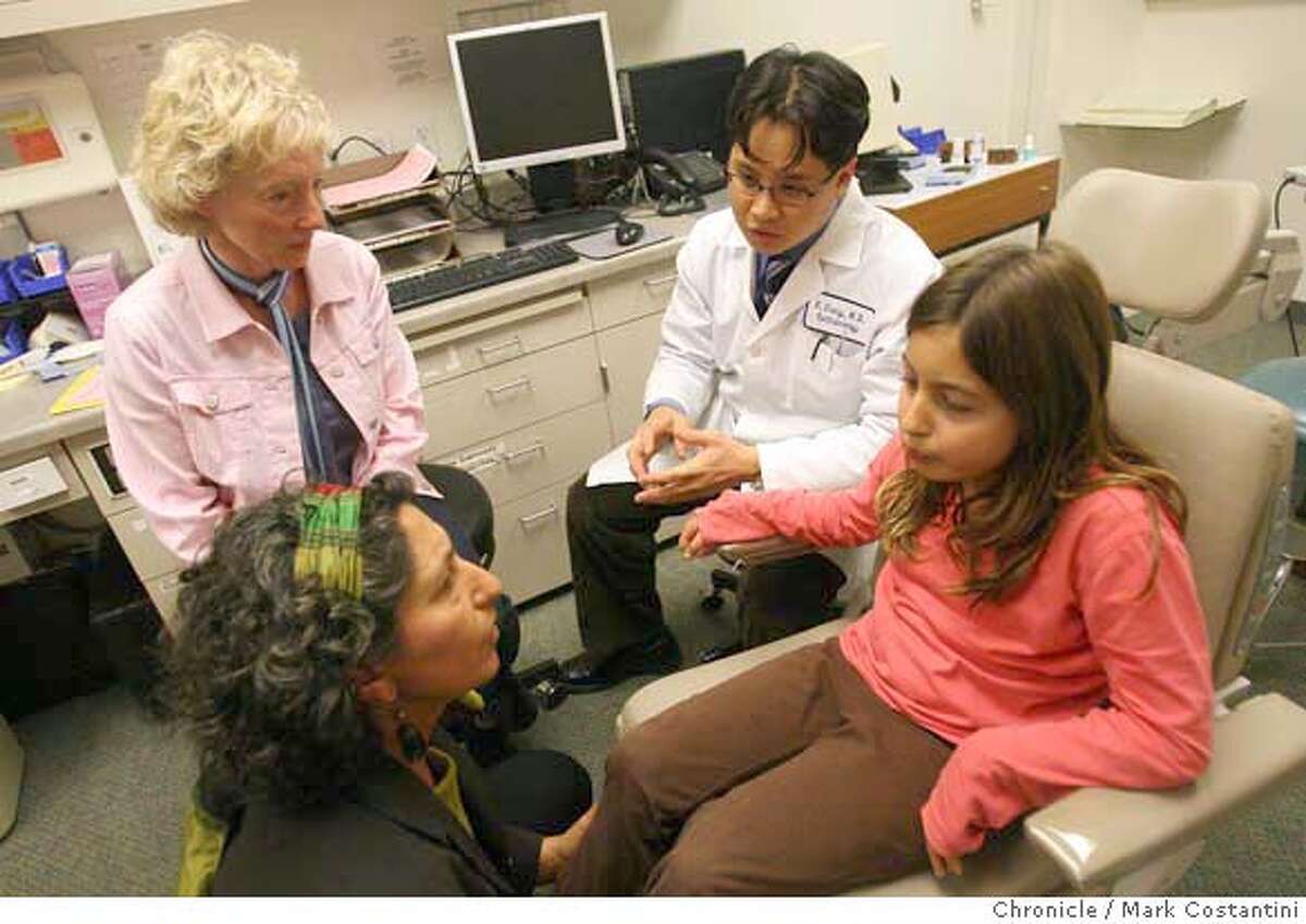 Joanna Smith (top left) at a doctor's visit with Margalit Mathan (bottom left), comforting her daughter Siona. Little Siona (she's seven) has glaucoma associated with her rheumatoid arthritis. Dr. Eugene Chang is the doctor (top right). The story is about the growing profession of health care advocates - people who are hired by patients to help them navigate our crazy health care system. Joanna Smith, who runs Healthcare Liaison of Berkeley, has a pretty extensive background in various areas of health care and branched off a couple years ago to start this buisness. She's concerned that anyone can cal themslves a "health care advocate" and wants to establish professional guidelines for the practice. Joanna at a doctor's visit with Margalit Mathan and Peter August and their daughter Siona. Little Siona (she's seven) has glaucoma associated with her rheumatoid arthritis. The Mathan/August family hired Joanna to help them coordinate her care and deal with a bunch of specialists/different options/etc. .PHOTO: Mark Costantini / The Chronicle Ran on: 10-18-2007 Joanna Smith (standing) is an advocate hired by Margalit Mathan (left) to help coordinate care for Mathans daughter Siona, 7, who suffers from arthritis and glaucoma.