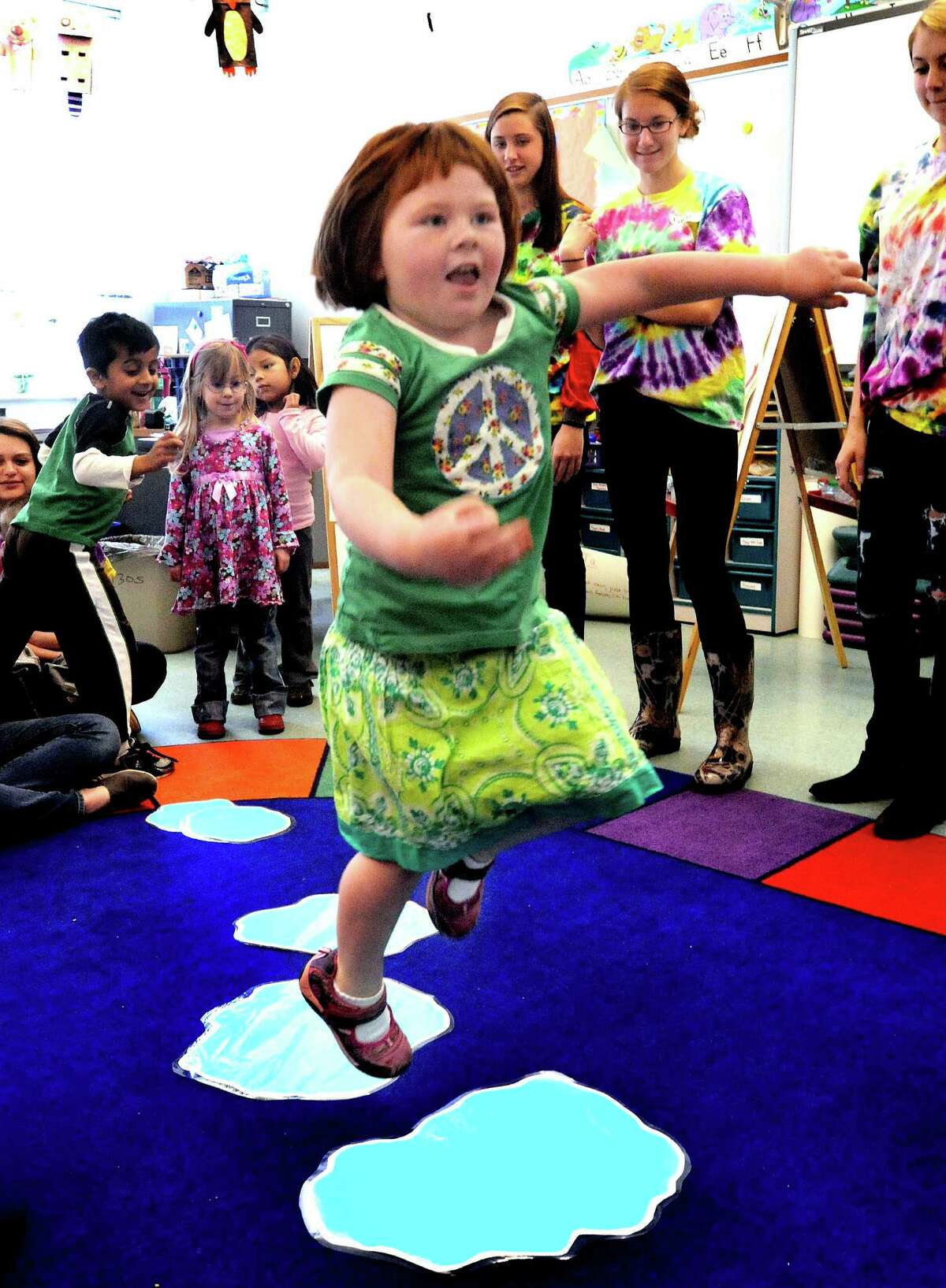 Emma Kavaneah, 5, jumps puddles during a child development class at New Milford High School Thursday, April 12, 2012.