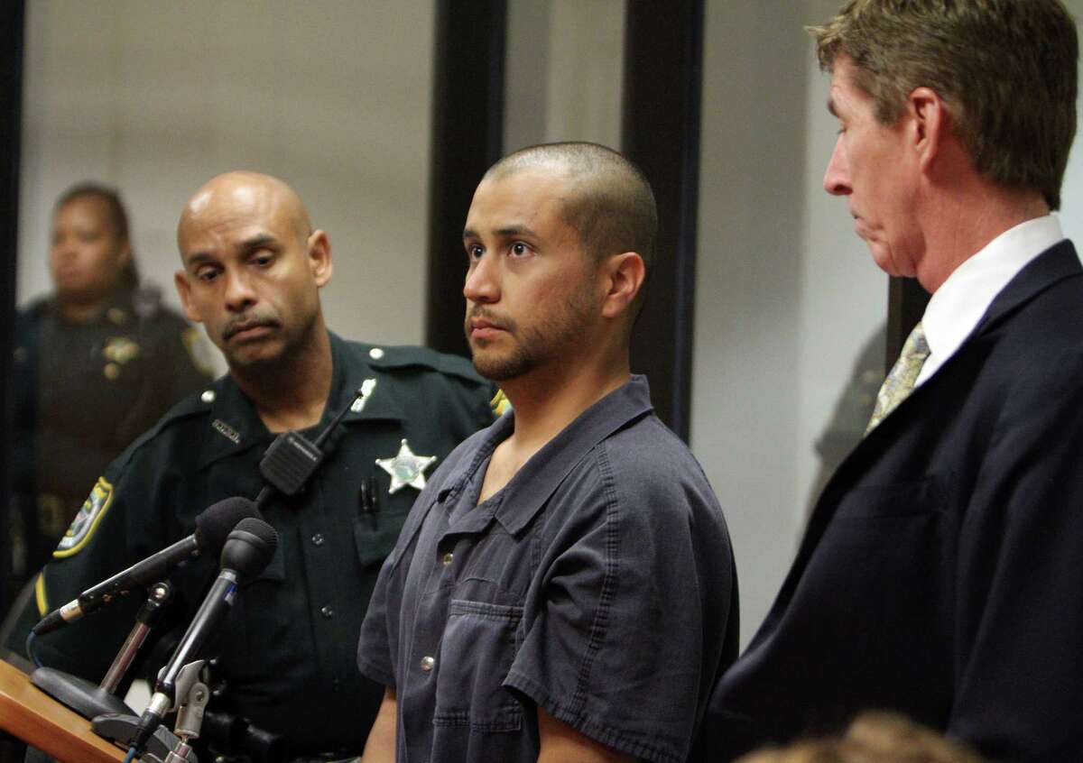 George Zimmerman, center, stands with a Seminole County Deputy and his attorney Mark O'Mara during a court hearing Thursday April 12, 2012, in Sanford, Fla. Zimmerman has been charged with second-degree murder in the shooting death of the 17-year-old Trayvon Martin. (AP Photo/Gary W. Green, Orlando Sentinel, Pool)