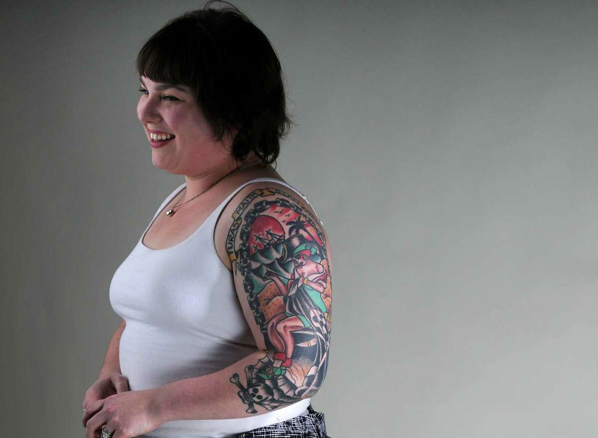 Molly Pensitan shows off a tattoo on her left arm, in the Times Union photography studio on Monday March 26, 2012 in Colonie, NY. (Philip Kamrass / Times Union )
