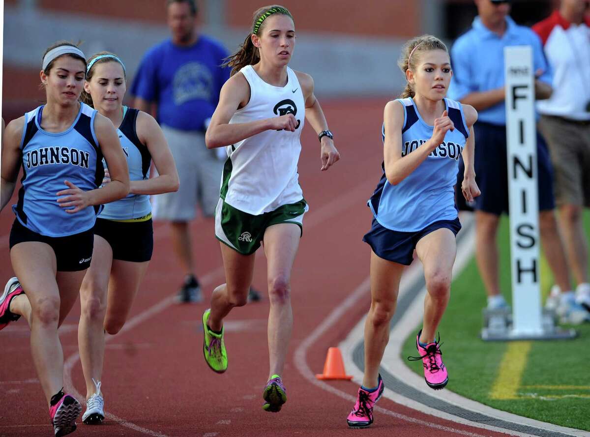 Natalie Langan of Johnson High School, right, and competitors are off at the start of the girls 3200 meter run during the finals of the District 26-5A track championships at Heroes Stadium on Thursday, April 12, 2012. Langan won the race. Billy Calzada / San Antonio Express-News