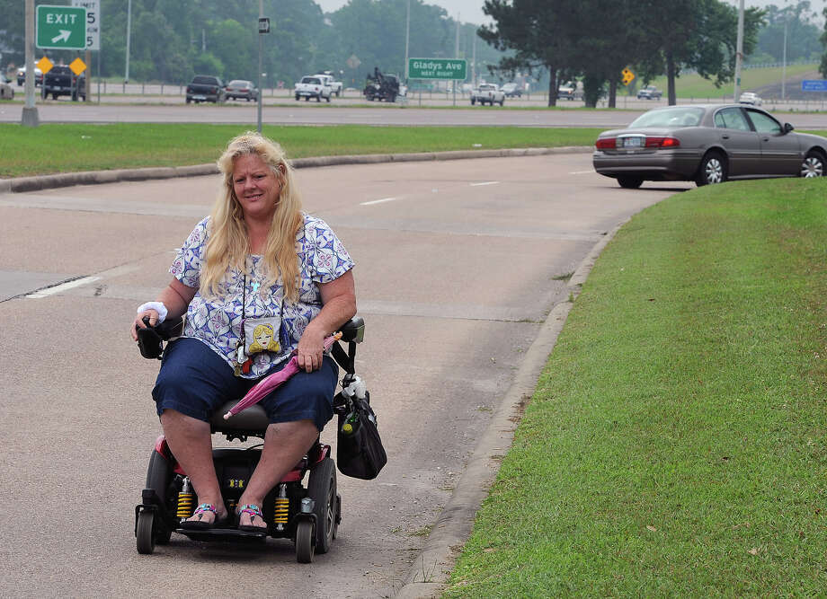 Pedestrians in motorized wheelchairs near French Road to get sidewalk
