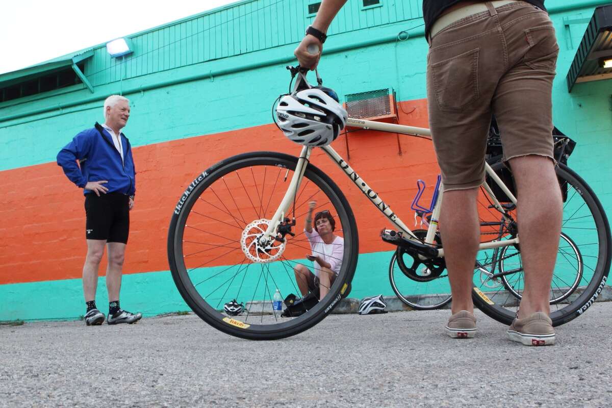 At Blue Line Bicycle Laboratory in the Heights, Jerry Kennedy, Jill Nepomnick and Stephen Nowakowski prepare to ride to work. (Johnny Hanson/Chronicle)