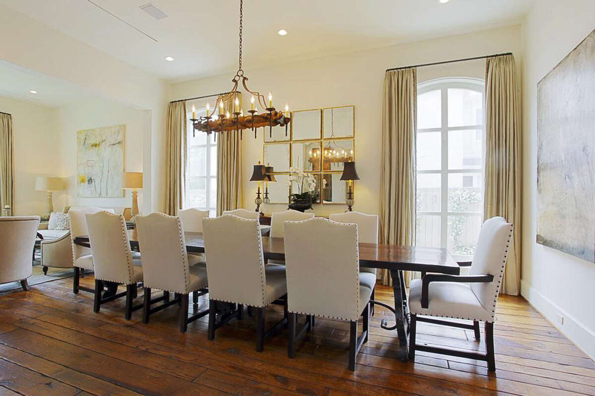The formal dining room features hardwood floors, a chandelier and seats at least 10.