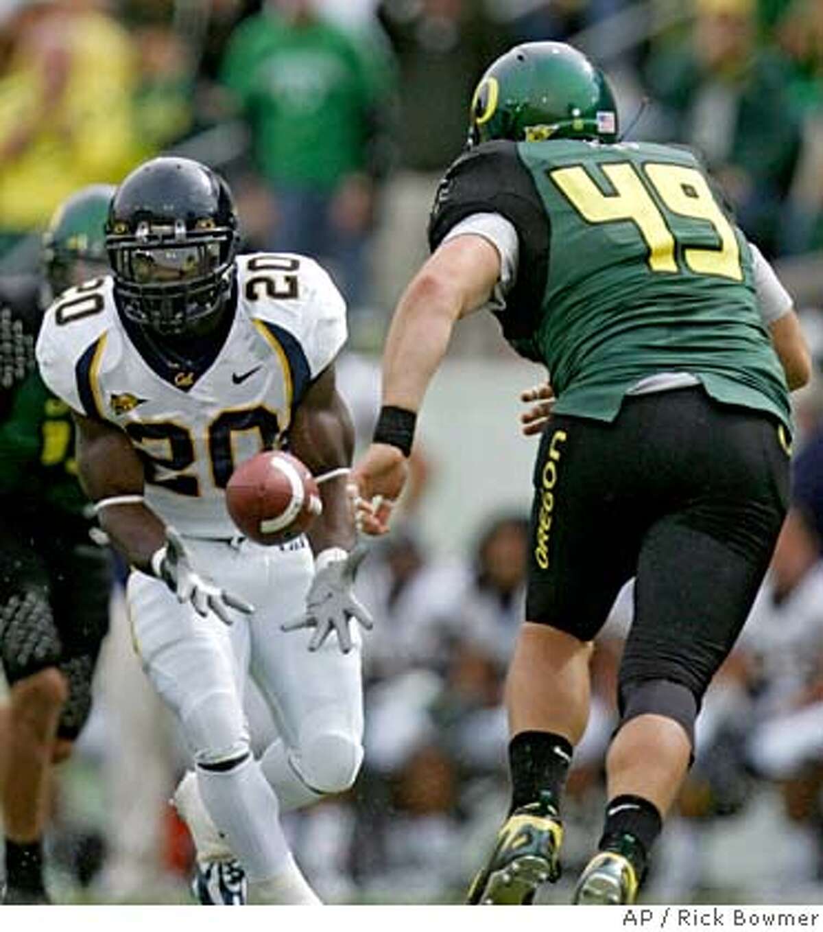 California's Justin Forsett (20) catches a pass as Oregon's Nick Reed (49) looks on in the second quarter of a football game Saturday, Sept. 29, 2007, in Eugene, Ore. (AP Photo/Rick Bowmer)