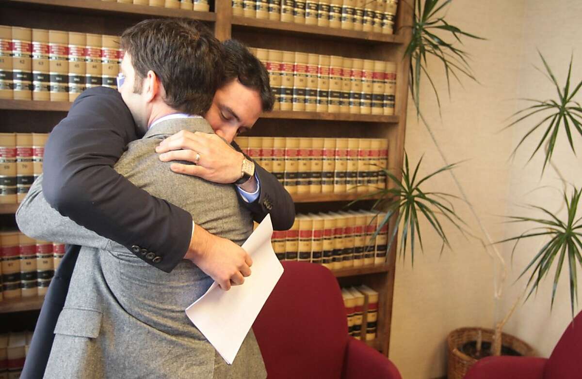 Christopher Cukor, right, and his brother, Alexander Cukor, hug after news conference about the Feb. 18 murder of their father, Peter Cukor on Friday, April 13, 2012, in Oakland, Calif. Peter Cukor was killed 15 minutes after making a 911 call for police help in Berkeley, Calif.