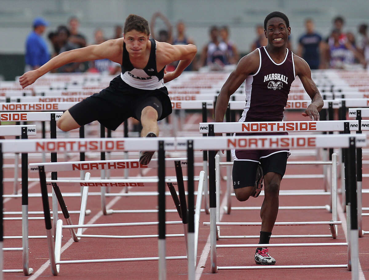 Clark's Presley Miller (left) edges out Marshall's Parabron Hawkins to take first in the 110-meter hurdles at the District 27-5A track meet at Gustafson Stadium on Friday, Apr. 13, 2012. Kin Man Hui/Express-News.