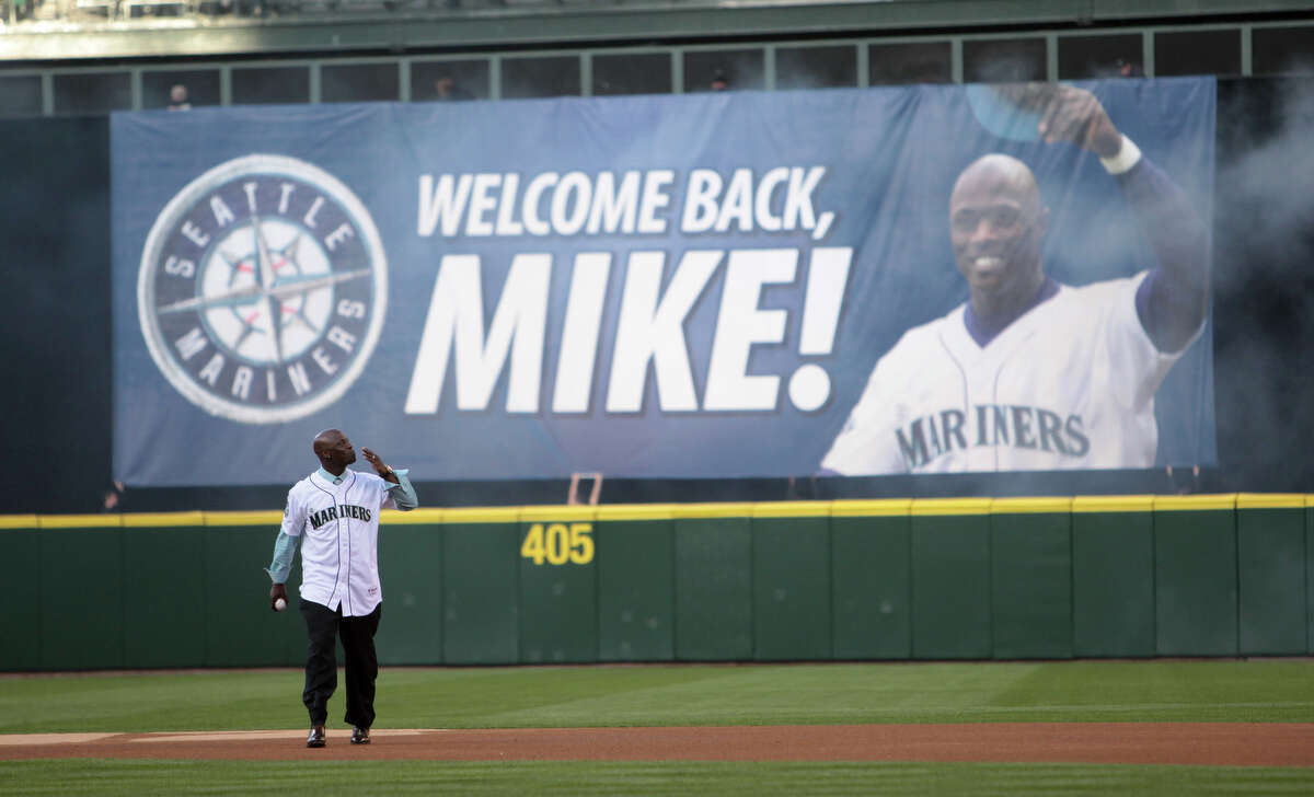 Newly retired Mariner Mike Cameron blows a kiss to fans before he throws out the ceremonial first pitch.