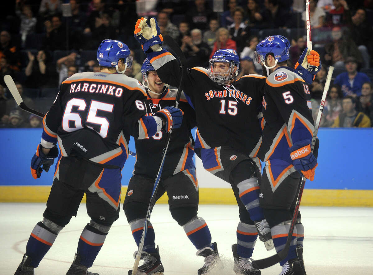From left; Sound Tiger teammates Tomas Marcinko, Matt Donovan, Steve Oleksy, and Blair Riley celebrate Oleksy's first period, and first career AHL goal, during their matchup with the Connecticut Whale at the Webster Bank Arena in Bridgeport on Sunday, March 25, 2012.
