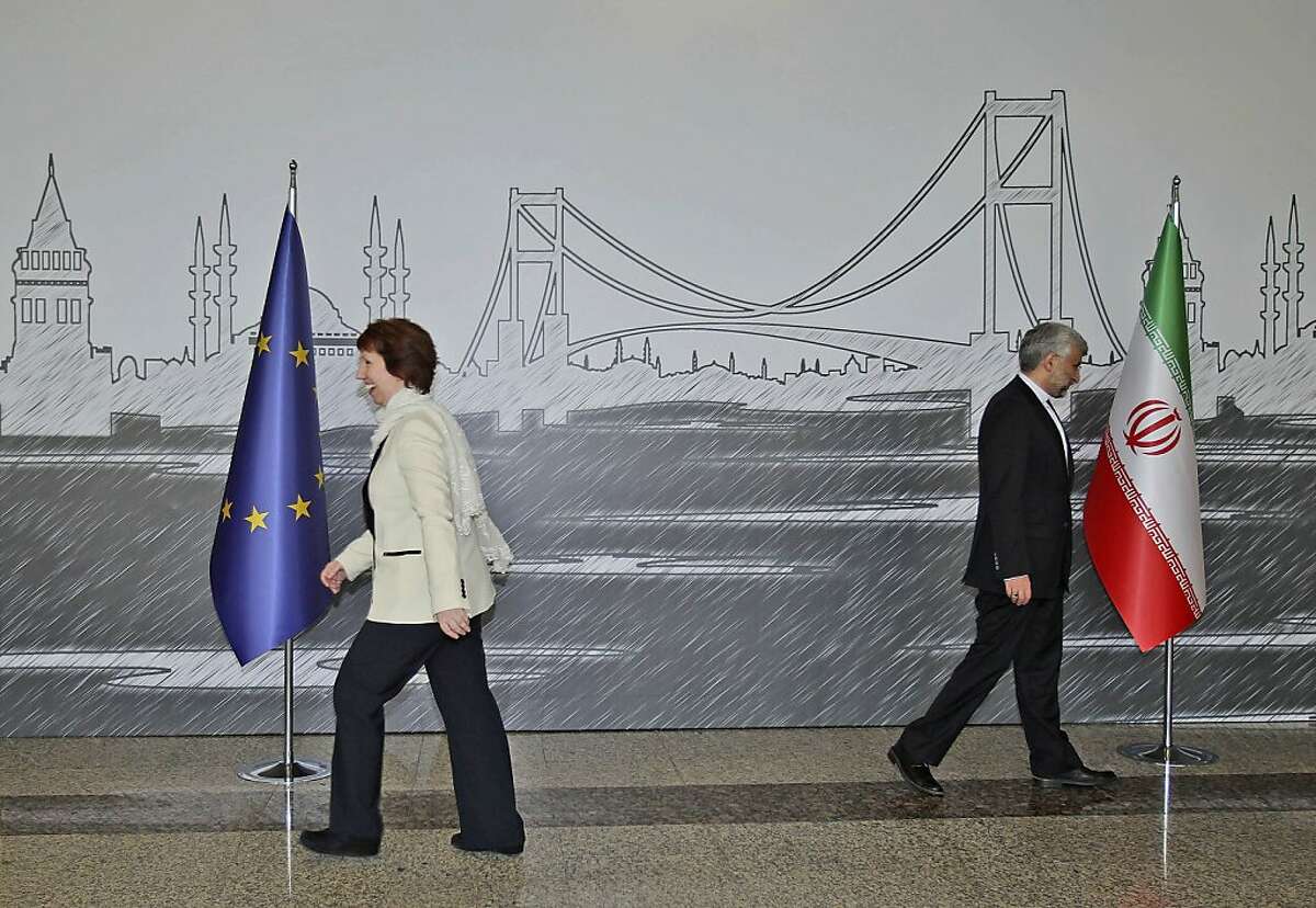 Iran's Chief Nuclear Negotiator Saeed Jalili, right, and EU Foreign Policy Chief Catherine Ashton leave after they posed for cameras before their meeting in Istanbul, Turkey, Saturday, April 14, 2012. After years of failure, Iran and the six world powers may finally make some progress on nuclear negotiations when they meet again Saturday if each side shows willingness to offer concessions the other seeks.(AP Photo/Tolga Adanali, Pool)