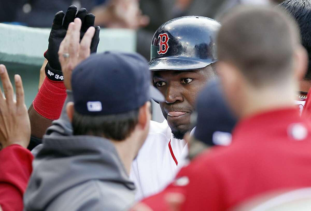Boston Red Sox's David Ortiz, center, celebrates his two-run home run with teammates in the dug out in the fifth inning of a baseball game against the Tampa Bay Rays in Boston, Saturday, April 14, 2012. (AP Photo/Michael Dwyer)