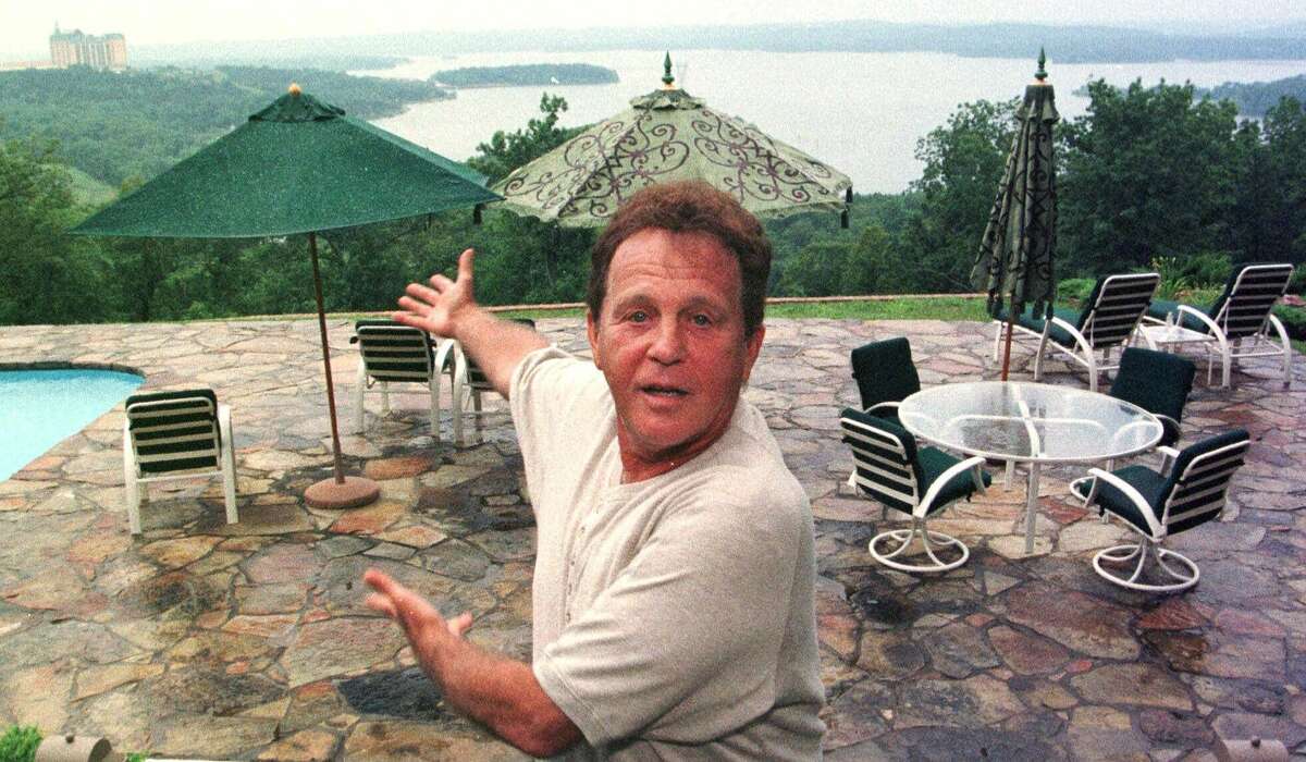 ADVANCE FOR WEEKEND JULY 22-25--Entertainer Bobby Vinton gives an impromptu performance at his Branson, Mo., home with Table Rock Lake as a backdrop, June 16, 1999. In 1992, Vinton opened the the Blue Velvet Theatre, a stunningly beautiful edifice in the heart of Branson's entertainment Strip, where he and almost all of his family perform. (AP Photo/John S. Stewart)