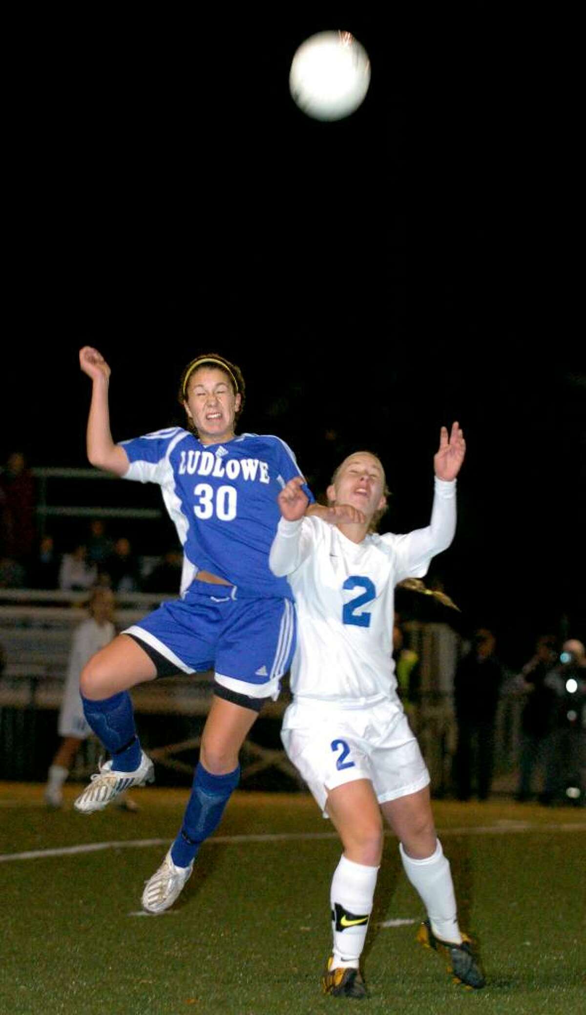 Fairfield Ludlowe's Mary Kamovitch and Glastonbury's Patricia McAllister both go for a header in the second half of Tuesday night's Class L semifinal soccer game at Municipal Stadium in Waterbury.