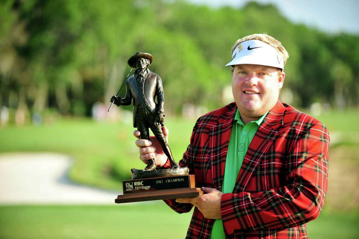 Carl Pettersson, of Sweden, holds the Heritage trophy on 18th fairway during the final round of the RBC Heritage golf tournament in Hilton Head Island, S.C., Sunday, April 15, 2012. Pettersson finished 14-under par. (AP Photo/Stephen Morton)