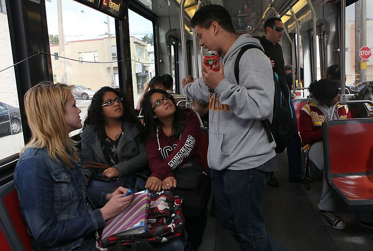 In this file photo, Lincoln High School freshmen Keziah Wohlers (far left) Nicolas Escobar (right, standing), Veronica Lima and her twin sister Irania Lima (middle), all 15 years old, on the L line after school on Taraval St. at 15th Ave. in San Francisco.