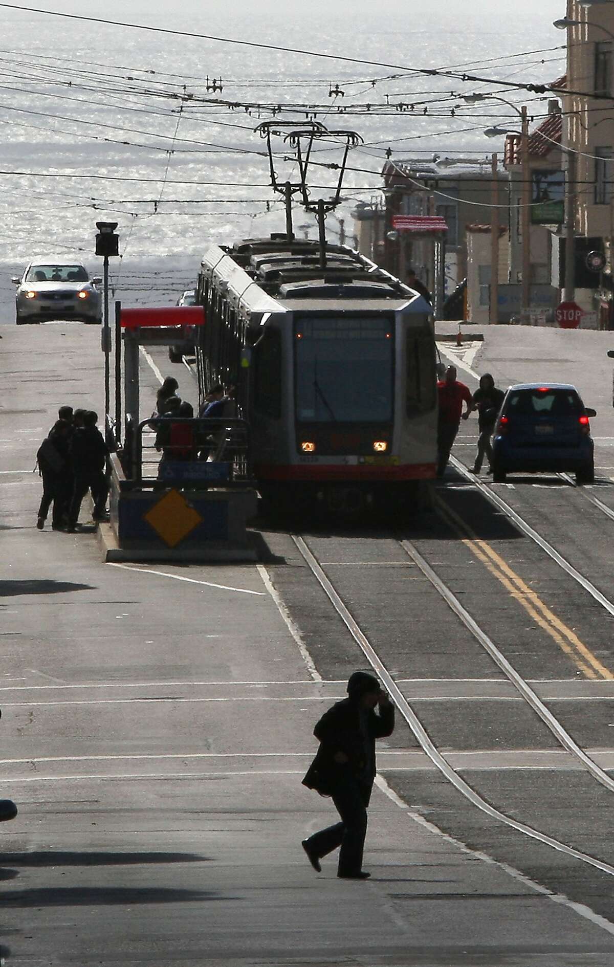 Pedestrians boarding the bus on Taravel St. at 22nd Ave. in San Francisco, Calif., on Friday, April 13, 2012. An SFMTA (San Francisco Municipal Transportation Agency) proposal for free Muni for youth will be considered by the MTA board early next week.